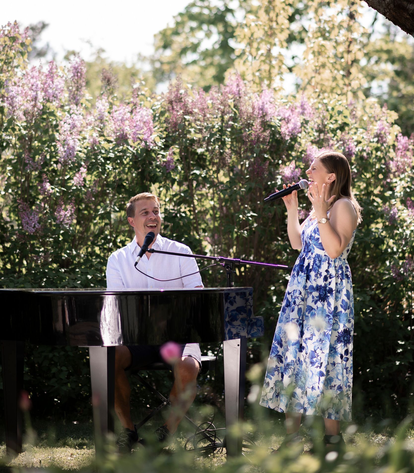 Amanda and David singing together while David plays the piano